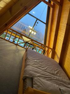 a bed in a room with a large window at Amasra Blue Horizon Bungalow in Eskiömerler