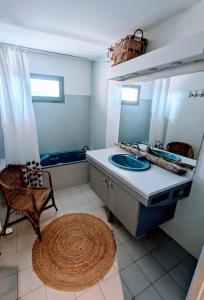a bathroom with a sink and a mirror at Renovated Charming Farm with Activities Around in Lagrand