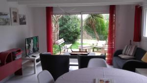 a living room with a view of a patio at Brennig in Penmarch