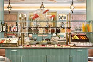 a buffet line with food on display in a restaurant at Grand Hotel Savoia in Genoa