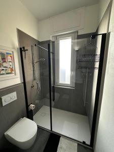 a bathroom with a shower and a toilet at Como's Hill Apartments Giungla in Lipomo +5 photos