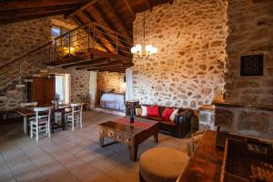 a living room with a couch and a table at Paradise cottage in Vinišće