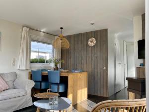 a living room with a couch and a table at Chalet Zilt Ameland in Hollum