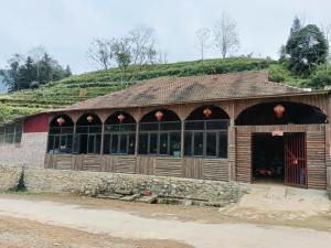 a building with a grassy hill on top of it at Homestay Sung Linh in Bắc Hà