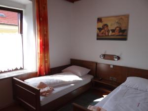 a small room with two beds and a window at Schlummerburg in Weißkirchen in Steiermark +8 photos