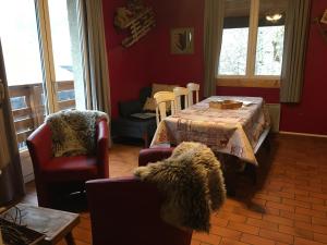 a living room with a table and chairs at CHALET Levante - Minimum 5 nuits in Gourette