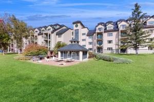 a large apartment building with a gazebo in a yard at Sunset Peak Efficiency at Rivergreen in Lincoln