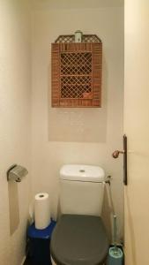 a bathroom with a toilet with a vent above it at Villa jean-marie in Sengouagnet +12 photos