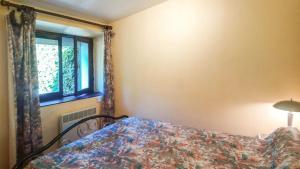 a bedroom with a bed and a window at Villa jean-marie in Sengouagnet