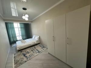 a living room with a couch and a window at Etno Naz in Bishkek