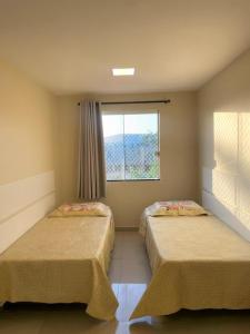 Ένα ή περισσότερα κρεβάτια σε δωμάτιο στο Caminho de Itacoatiara