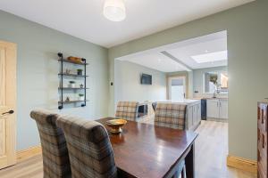 una cucina e una sala da pranzo con tavolo e sedie di Pickin Cottage a Altofts