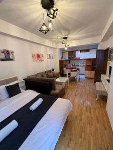a bedroom with a bed and a living room at Petreski Apartments 1 in Ohrid
