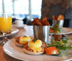 a plate of food with eggs and fries on a table at Willow Pond Satellite B&B in Port Perry