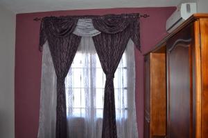 a window with black and white curtains in a room at RS VILLA private apartment with pool and free wifi in Flic-en-Flac +24 photos