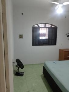 a room with a bed and a window in it at Sua paz está aqui in Mongaguá