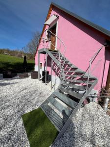 a staircase leading up to a pink building at Šumava apartmán U Kočiček in Strašice +8 photos