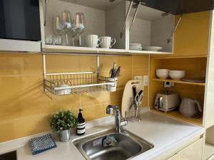 a kitchen with a sink and a counter top at Seoul Station Studio-City View in Seoul +19 photos