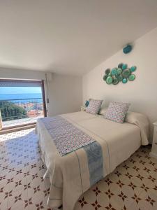 a bedroom with a bed and a large window at Attico Orizzonte, splendida vista sul golfo IUN T2810 in Cala Gonone
