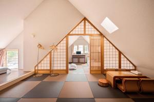 an attic room with a large glass wall at Hakuba Sun Valley Hotel in Hakuba