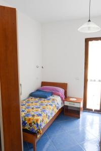 Postel nebo postele na pokoji v ubytování Appartamenti Le Giare Acciaroli
