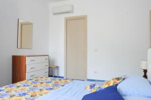 Postel nebo postele na pokoji v ubytování Appartamenti Le Giare Acciaroli