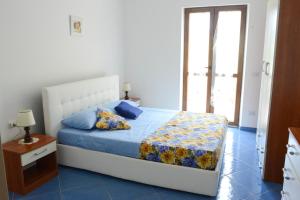 Postel nebo postele na pokoji v ubytování Appartamenti Le Giare Acciaroli