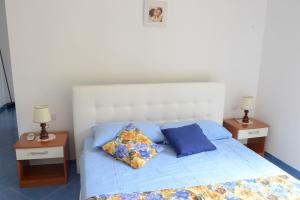 Postel nebo postele na pokoji v ubytování Appartamenti Le Giare Acciaroli