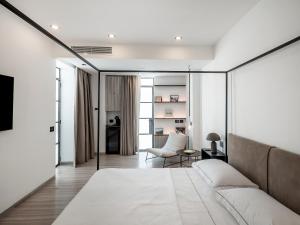 a bedroom with a couch and a living room at Porta Suite in Capri