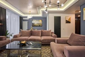 a living room with a couch and a table at F&B Spa Resort (ex. Fomich Hotel) in Bukovel