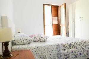 Postel nebo postele na pokoji v ubytování Appartamenti Le Giare Acciaroli