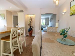 a kitchen and living room with a table and chairs at 6 Barleycroft in Great Yarmouth
