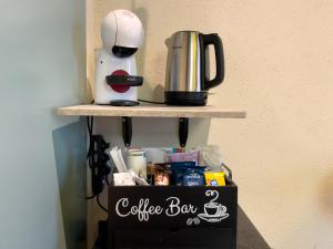 a coffee box with a coffee maker on a shelf at Residencia Barrio B&b - 3 suites - 6 Minutes from Amalfi Coast in Cava deʼ Tirreni