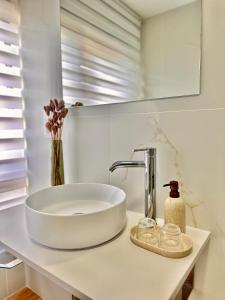 a bathroom with a white sink on a counter at GH Beiramar in Cee +24 photos