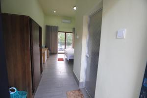 a hallway with a door to a bedroom with a bed at M Y hotel in Dili
