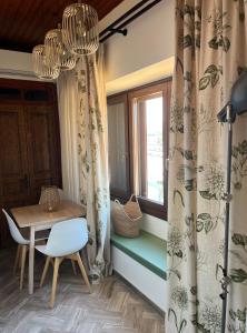 a dining room with a table and a window at Martsalo in Lefkada Town
