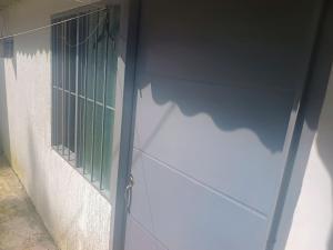 a door with a green window on the side of a building at La fonda in Santa Rosa de Cabal