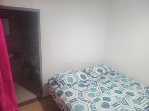 a bedroom with a bed with a pillow on it at La fonda in Santa Rosa de Cabal +1 photo