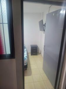 a kitchen with a white refrigerator in a room at La fonda in Santa Rosa de Cabal