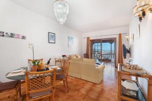 a living room with a table and a dining room at Gigantes Apartament Sea View in Acantilado de los Gigantes