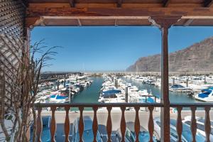 a view of a marina from a balcony at Gigantes Apartament Sea View in Acantilado de los Gigantes