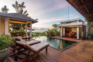 a villa with a swimming pool and a house at Airis Luxury Villas and Spa in Uluwatu