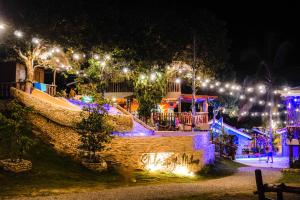 a group of houses lit up at night with lights at Mad Monkey Siquijor in Siquijor