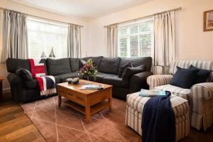 a living room with two couches and a coffee table at Beach Approach House - 30 steps from beach - Luxury house - kids slide and chill-out room - amazing location - garden in Filey