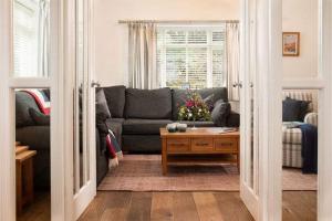 a living room with a couch and a table at Beach Approach House - 30 steps from beach - Luxury house - kids slide and chill-out room - amazing location - garden in Filey +13 photos