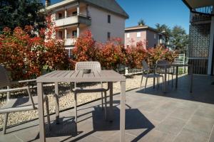 a wooden table and chairs on a patio at roveleto camere in Roveleto
