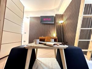 a table in a room with a sign on the wall at SuiteSigismondo-L'appartamento Più Centrale Di Rimini in Rimini