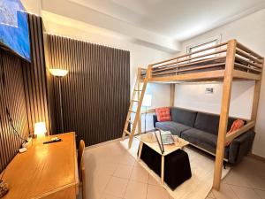 a living room with a bunk bed and a couch at SuiteSigismondo-L'appartamento Più Centrale Di Rimini in Rimini
