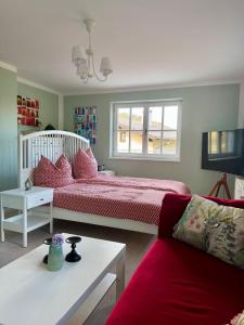 a living room with a bed and a couch at LIVA LIVING, Apartments mit Berg- und Seeblick, große Terrassen in Sankt Gilgen +12 photos