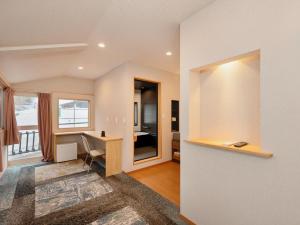 a living room with a desk and a bedroom at Hakuba Sun Valley Hotel in Hakuba +144 photos